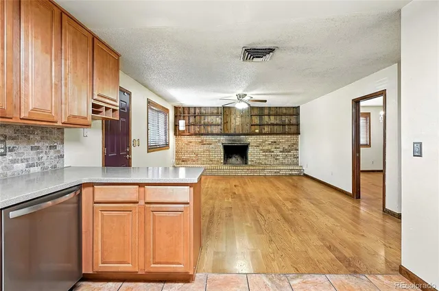 a kitchen with granite countertop a stove and cabinets