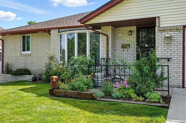 a view of a house with a yard and plants
