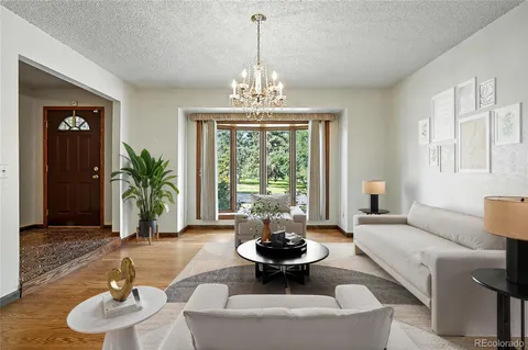 a living room with furniture and a chandelier