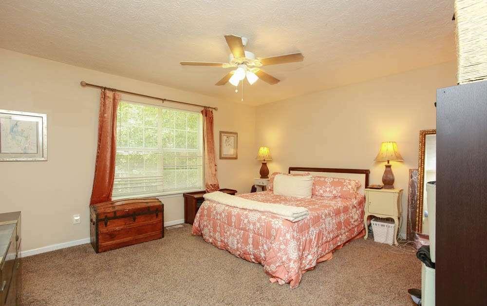 177 Rustin Drive Dallas, GA 30157 - Photo 12 of 26 a bedroom with a bed and a window