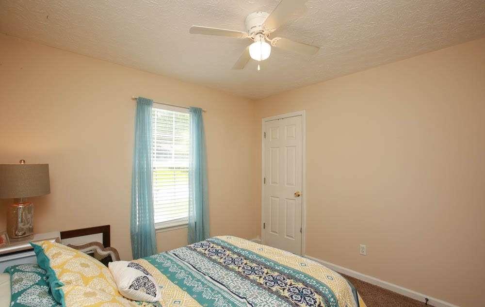 177 Rustin Drive Dallas, GA 30157 - Photo 22 of 26 a bedroom with a bed and a chandelier