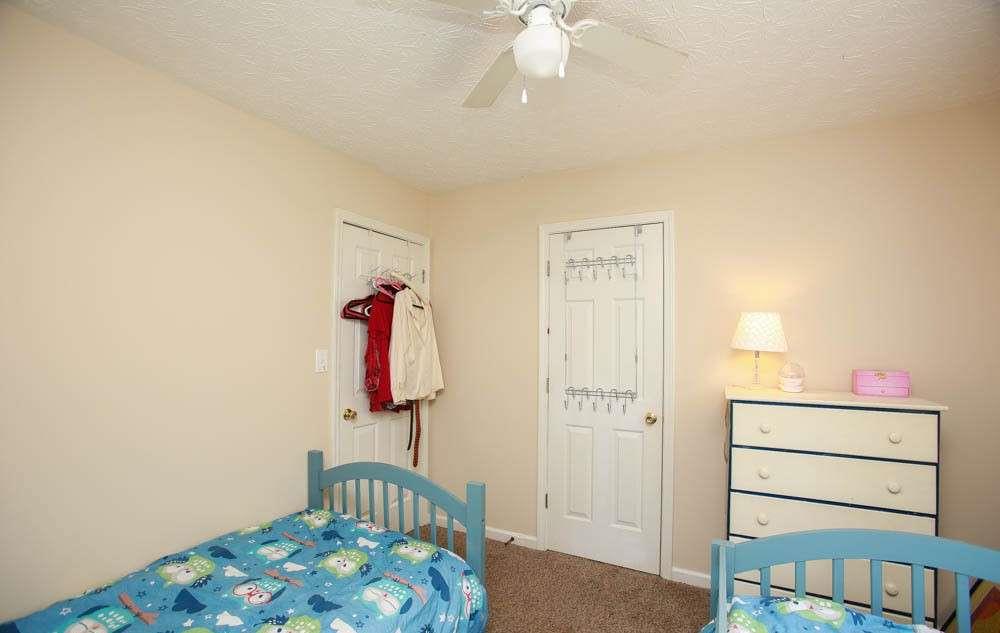 177 Rustin Drive Dallas, GA 30157 - Photo 25 of 26 a bedroom with a bed and a chandelier