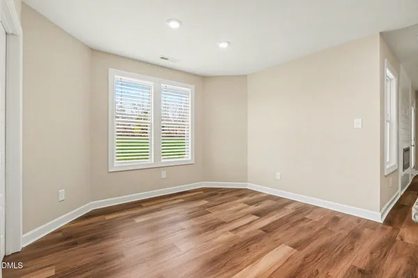 a bedroom with a large bed a chandelier and closet
