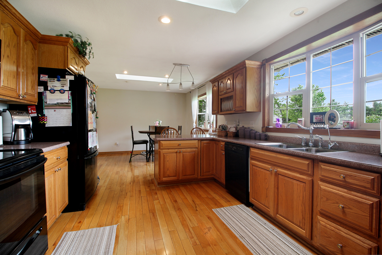 9763 West 1000S Road Bonfield, IL 60913 - Photo 6 of 23 a kitchen with stainless steel appliances granite countertop wooden floor a stove a sink dishwasher and cabinets with wooden floor