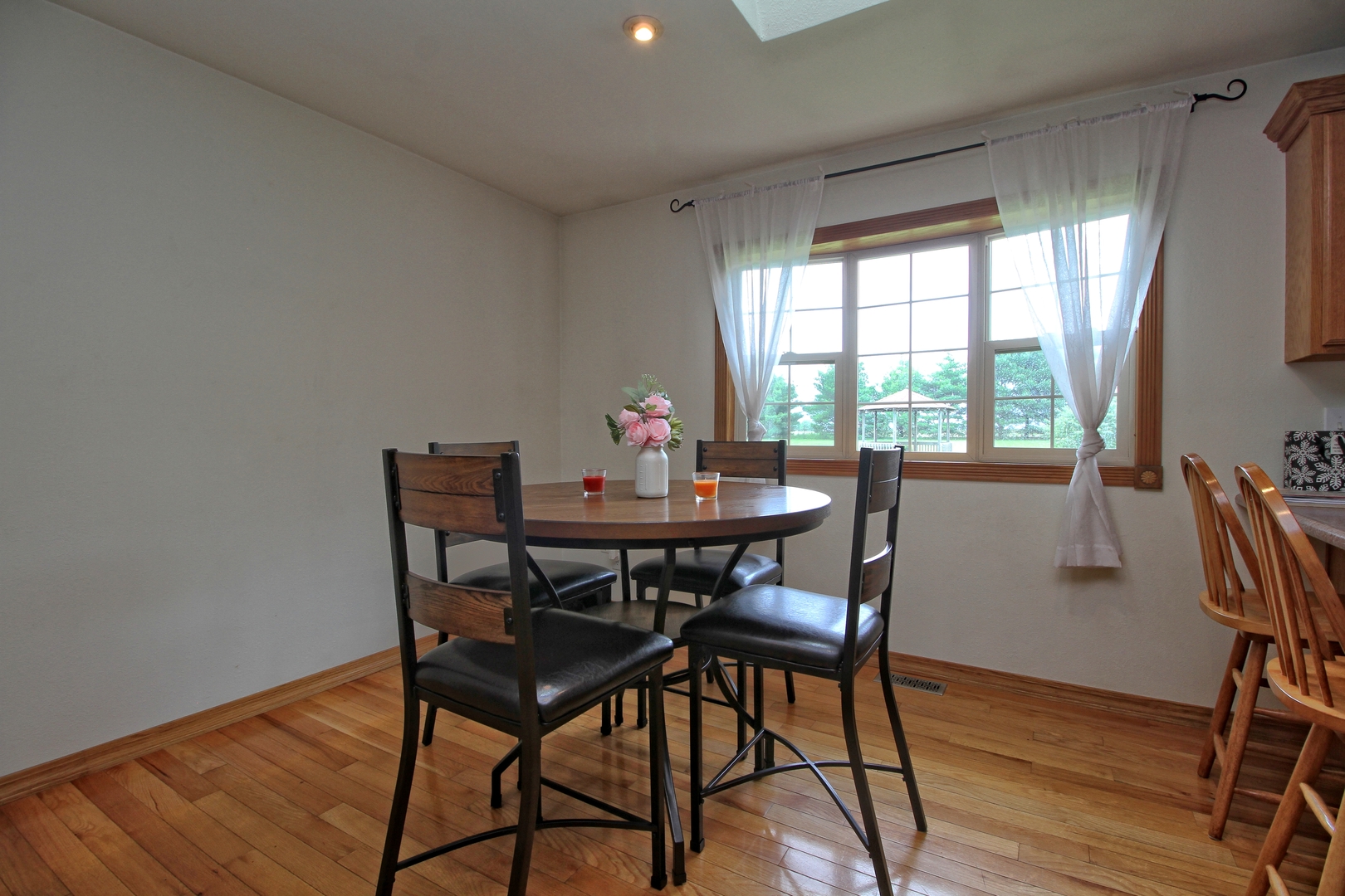 9763 West 1000S Road Bonfield, IL 60913 - Photo 7 of 23 a view of a dining room with furniture window and wooden floor