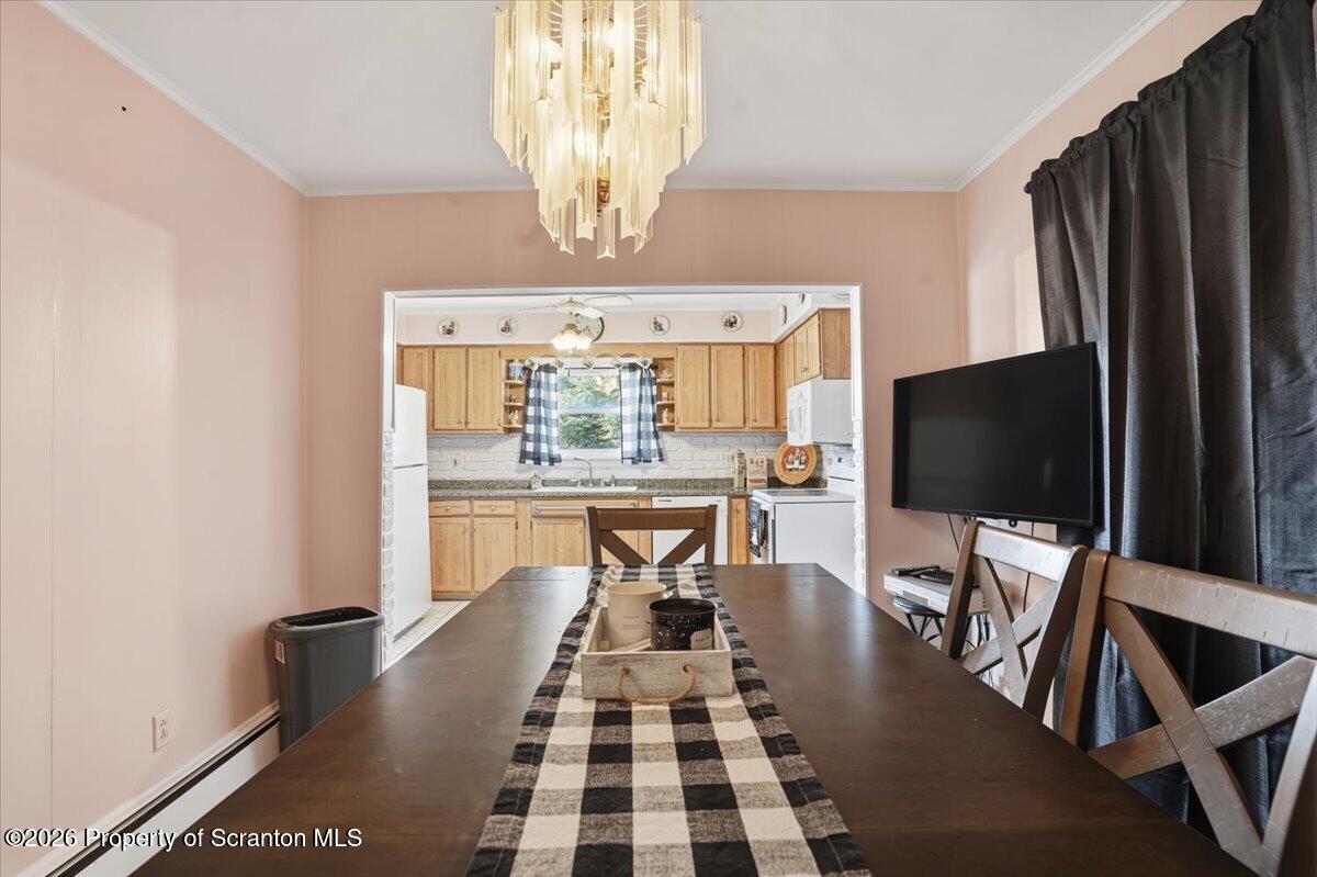 101 Stone Street Moosic, PA 18507 - Photo 14 of 53 a view of a dining room with furniture a chandelier and wooden floor