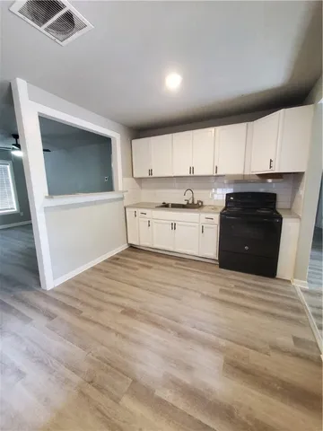 a bathroom with sink a mirror and a washer
