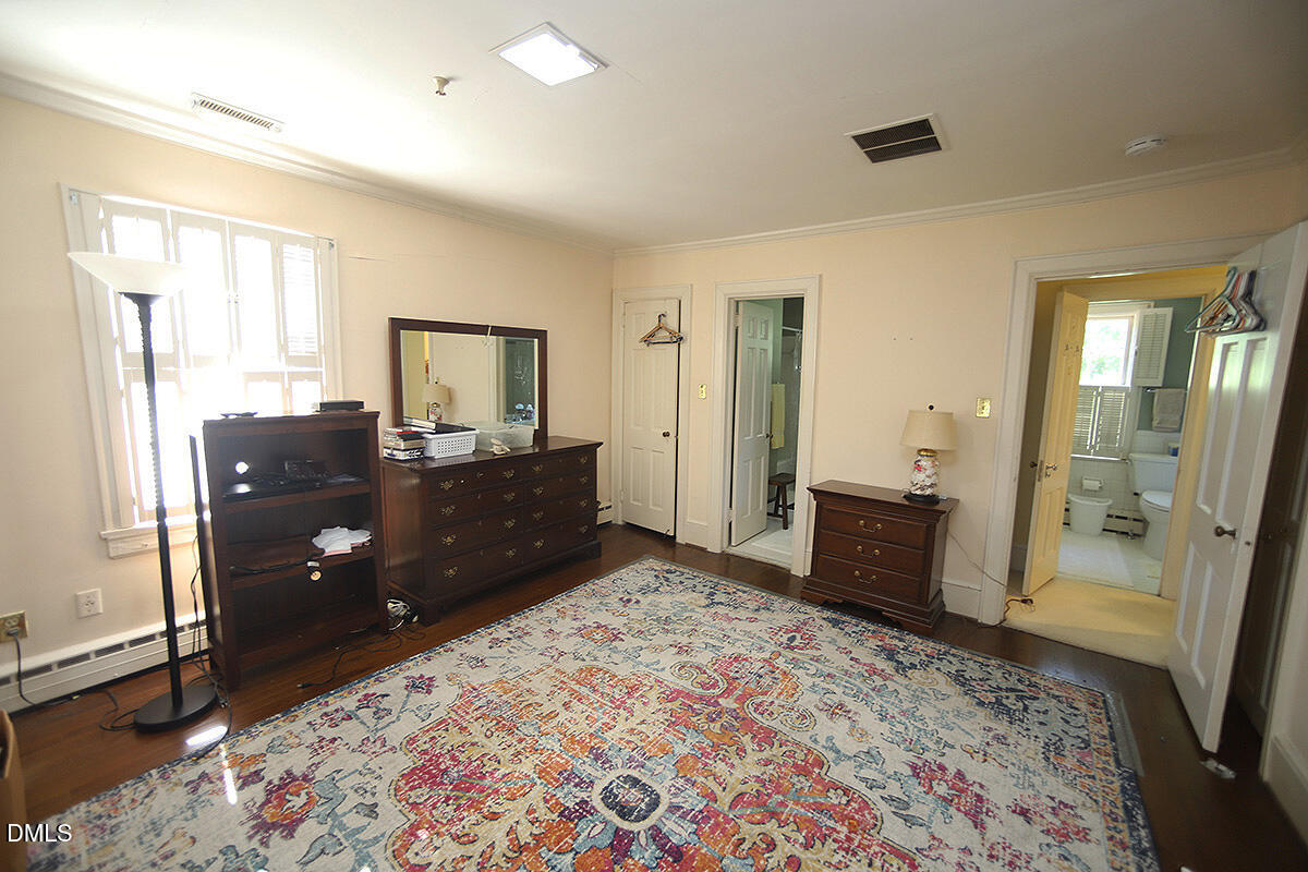 2601 York Road Raleigh, NC 27608 - Photo 11 of 24 a bedroom with a bed and wooden floor