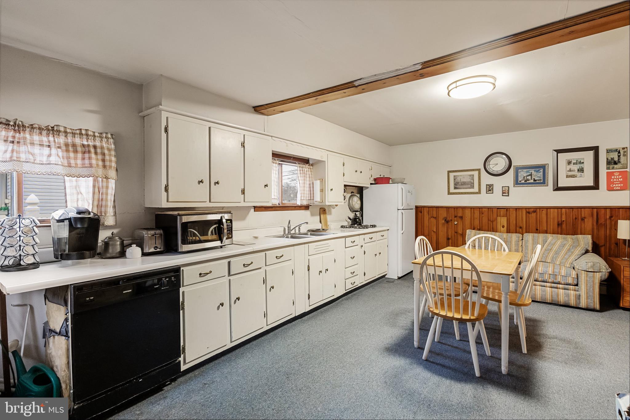 708 Bem Street Riverside, NJ 08075 - Photo 15 of 26 a kitchen with stainless steel appliances a sink cabinets and wooden floor