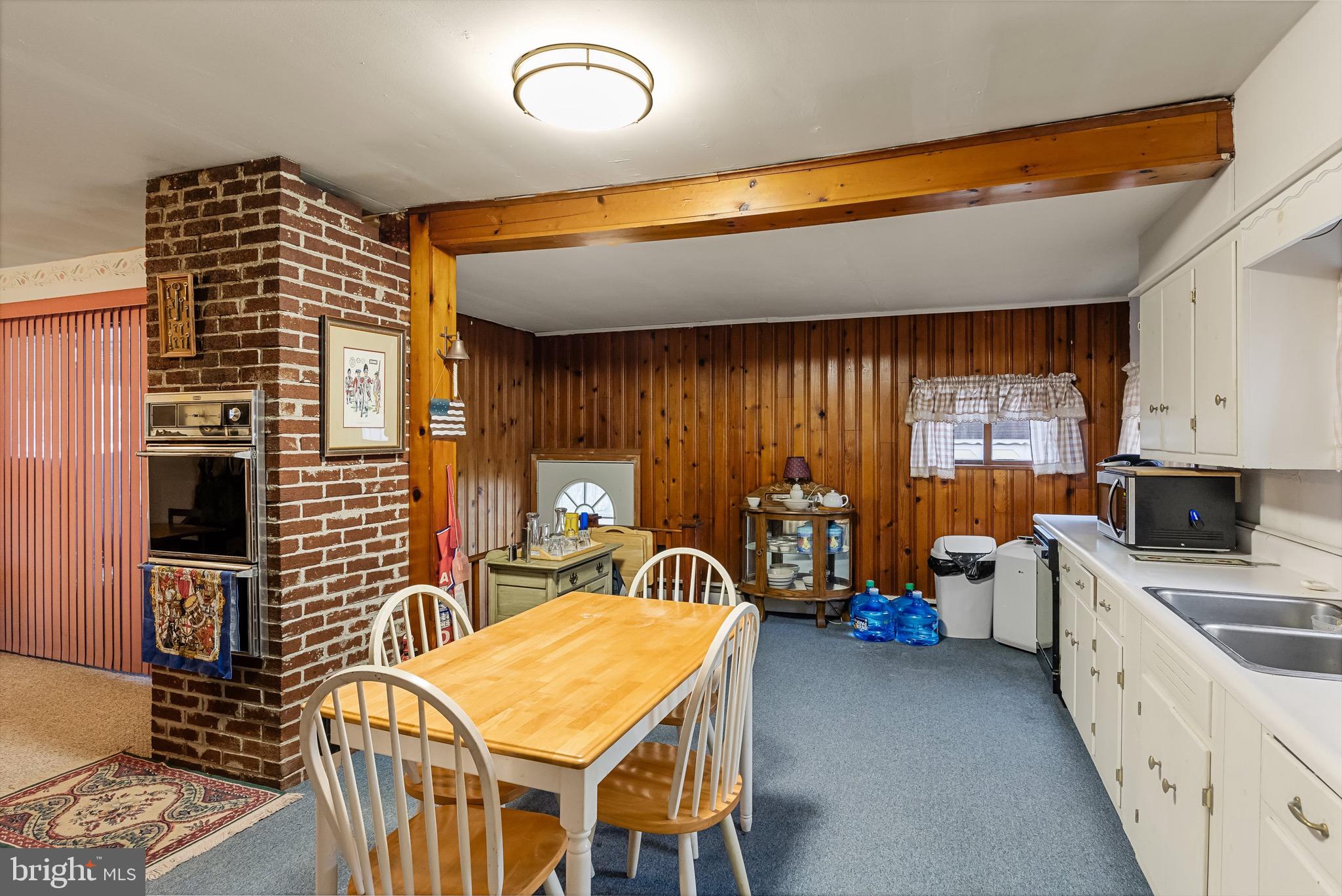 708 Bem Street Riverside, NJ 08075 - Photo 16 of 26 a kitchen with a table chairs and a refrigerator