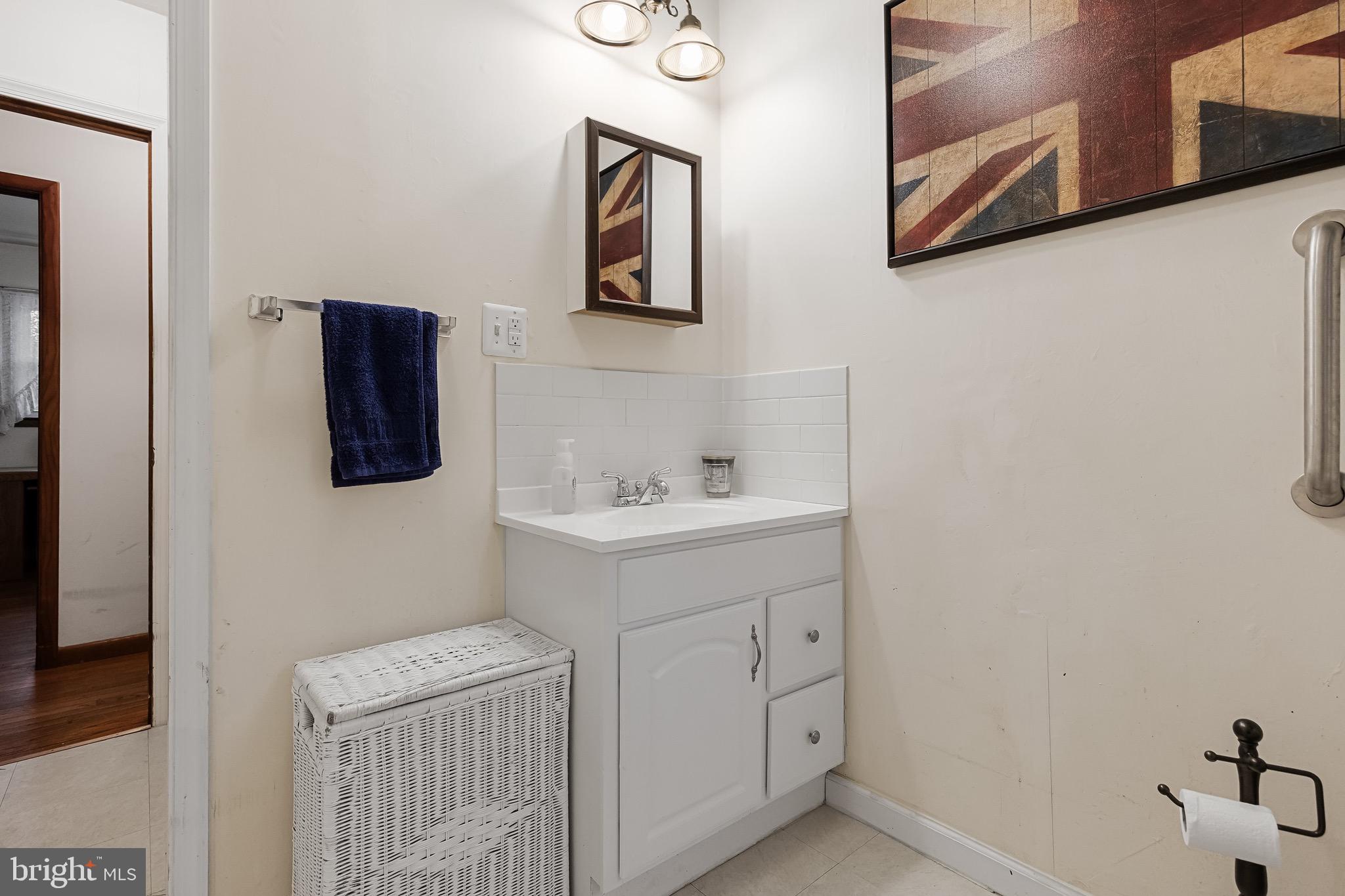 708 Bem Street Riverside, NJ 08075 - Photo 19 of 26 a bathroom with a sink a mirror and vanity