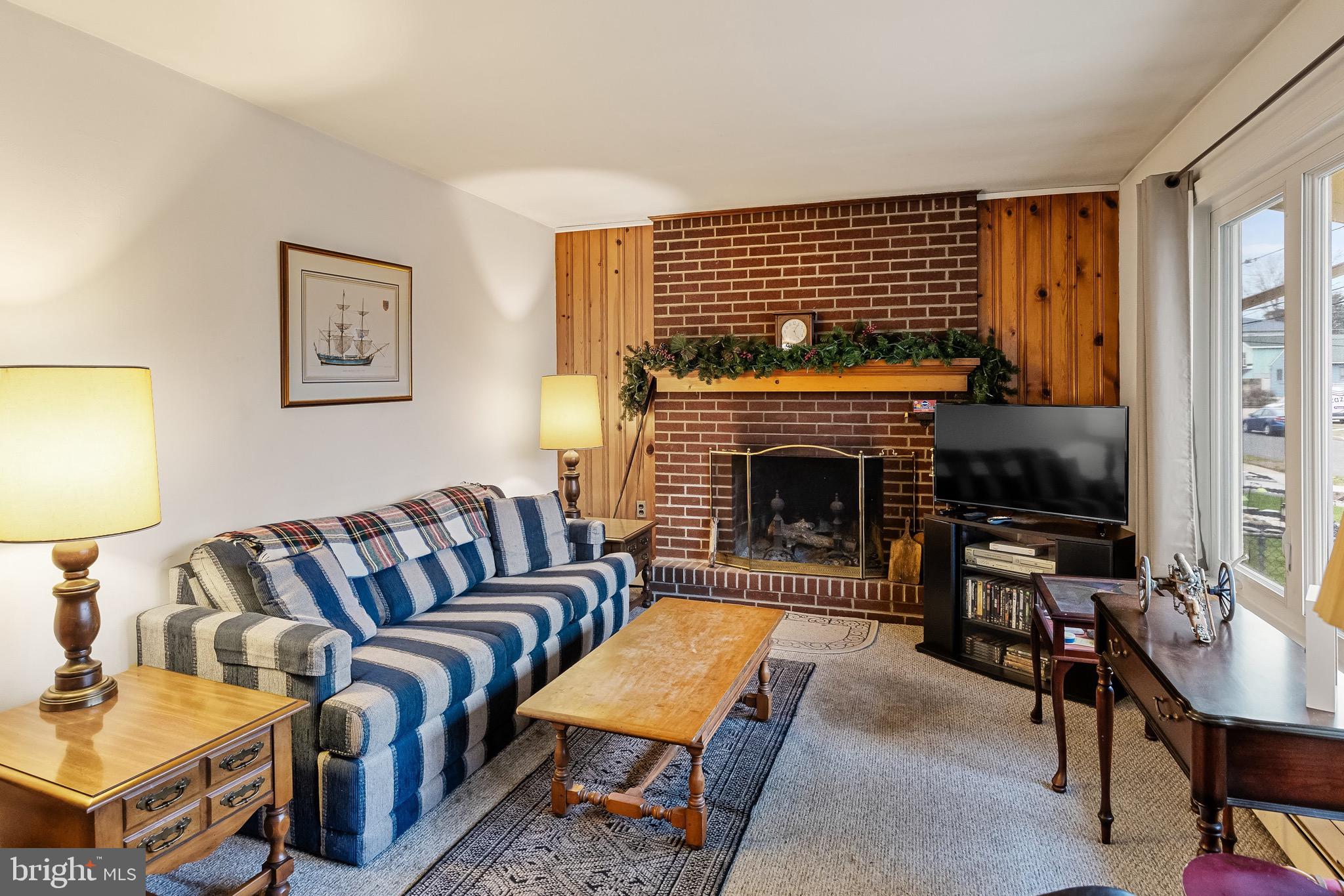 708 Bem Street Riverside, NJ 08075 - Photo 6 of 26 a living room with furniture a flat screen tv and a fireplace