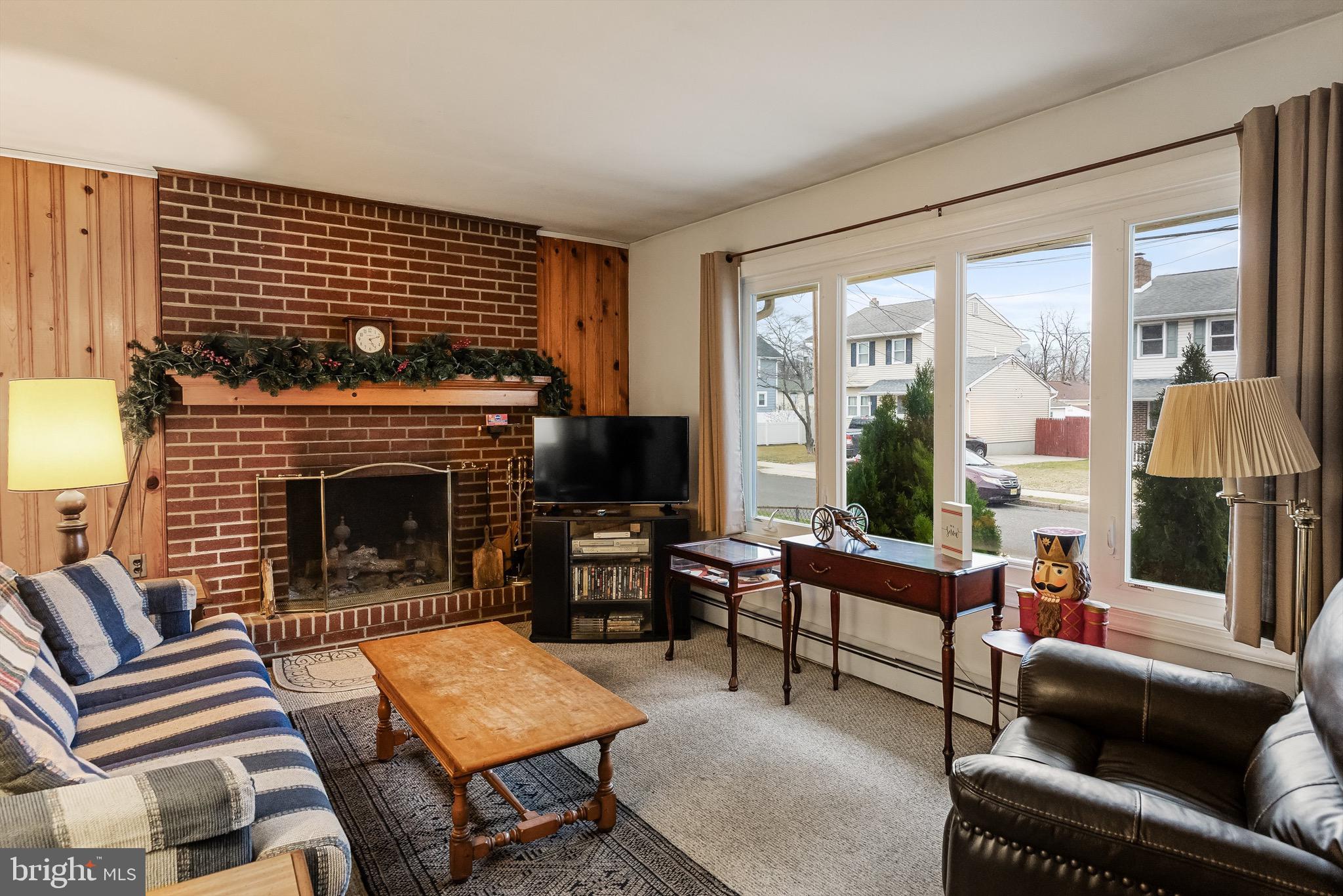 708 Bem Street Riverside, NJ 08075 - Photo 7 of 26 a living room with furniture a fireplace and a floor to ceiling window