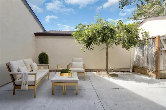 a backyard of a house with table and chairs
