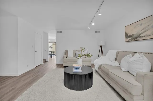 a living room with furniture and a painting