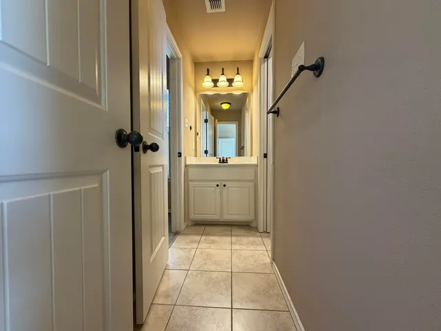 a view of a hallway with a room
