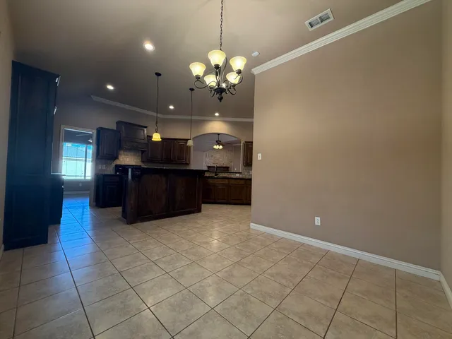 a view of a kitchen with a sink and chandelier