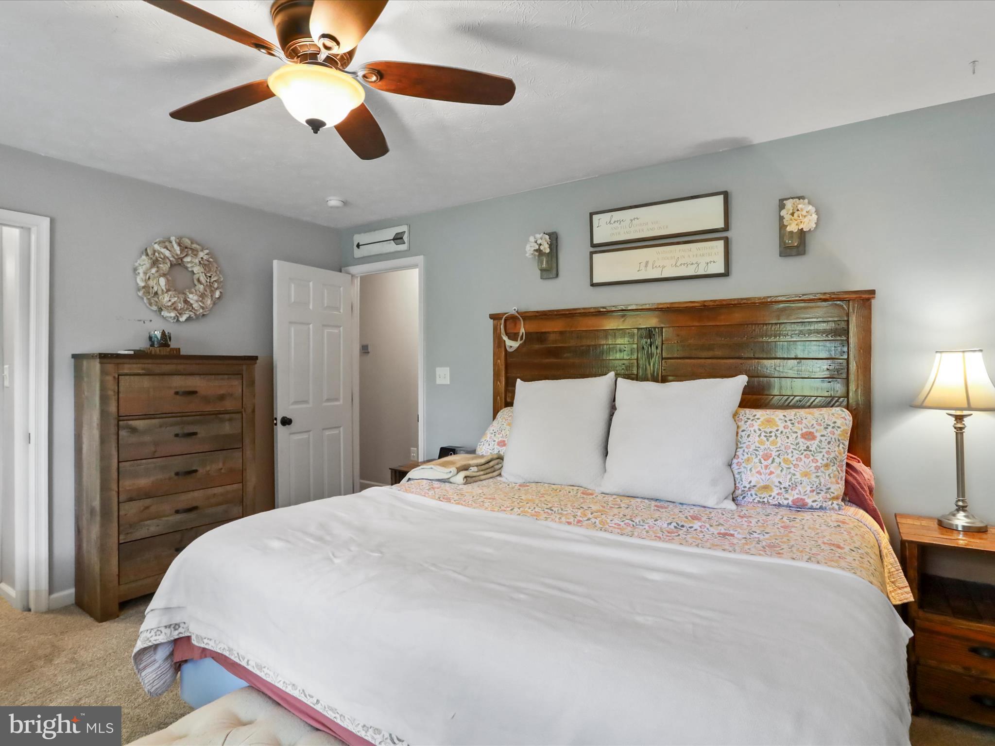 32 Greenfield Road Front Royal, VA 22630 - Photo 12 of 49 a bedroom with a bed and a chandelier