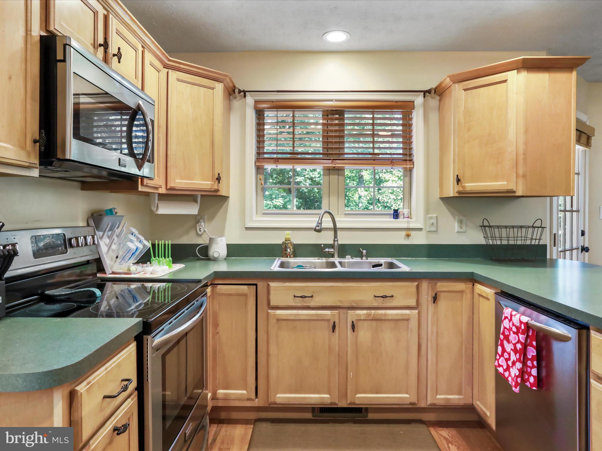 32 Greenfield Road Front Royal, VA 22630 - Photo 30 of 49 a kitchen with stainless steel appliances granite countertop a stove a sink and a microwave