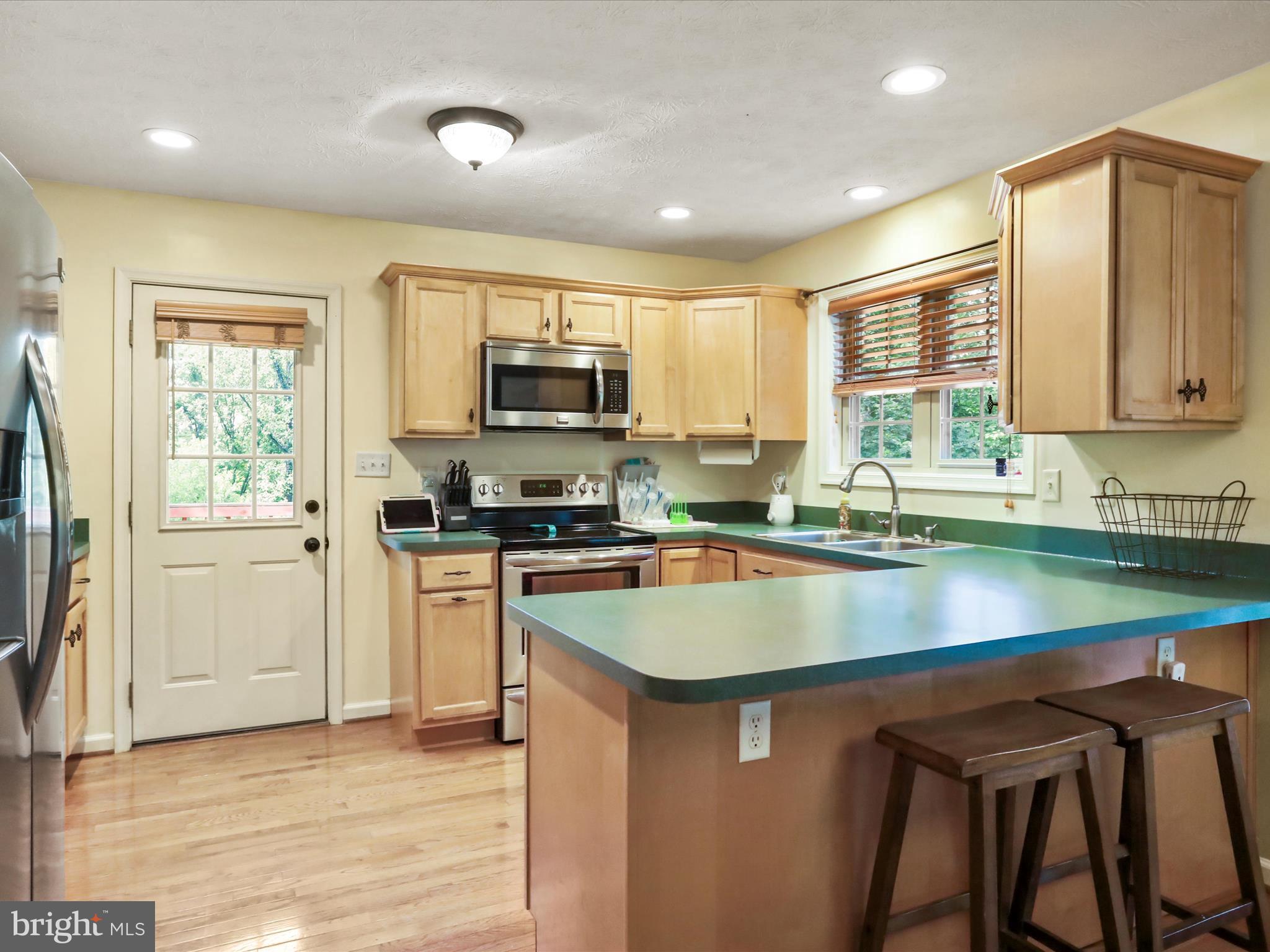 32 Greenfield Road Front Royal, VA 22630 - Photo 31 of 49 a kitchen with stainless steel appliances granite countertop a sink a stove and a microwave