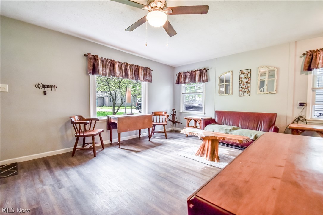 1969 Paisley Road Madison, OH 44057 - Photo 6 of 20 Living area featuring wood-finish flooring, light gray wall paint, and multiple windows