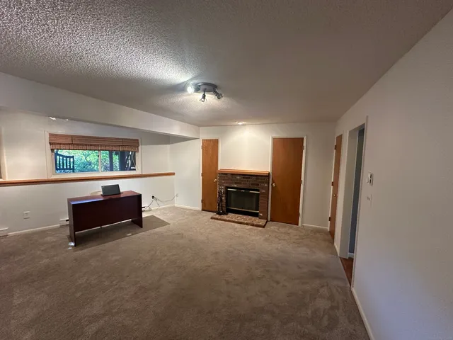 a view of a livingroom with furniture and a fireplace