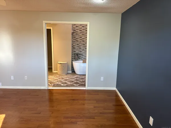 a view of wooden floor and chair in a room