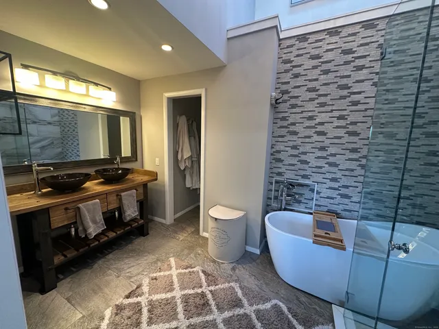 a bathroom with a bathtub and a toilet