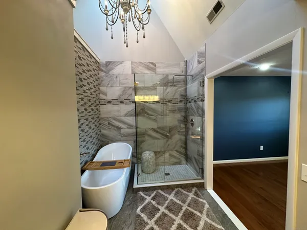 a bathroom with a toilet and a shower