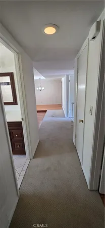 a view of a hallway to rooms