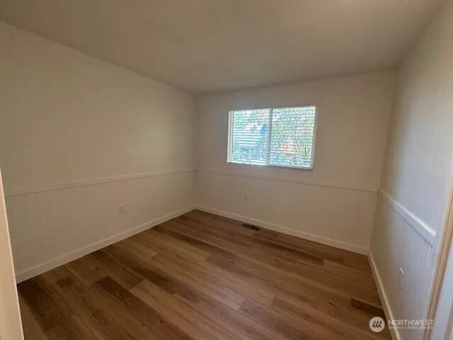 a view of kitchen with granite countertop cabinets and wooden floor
