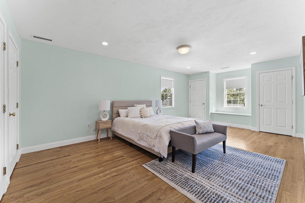 77 Hawthorne Road Waltham, MA 02451 - Photo 14 of 27 a spacious bedroom with a bed and wooden floor