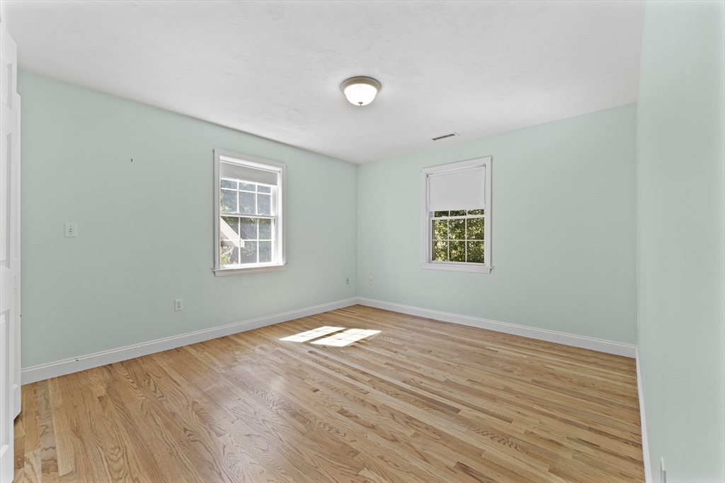 77 Hawthorne Road Waltham, MA 02451 - Photo 18 of 27 an empty room with wooden floor and windows