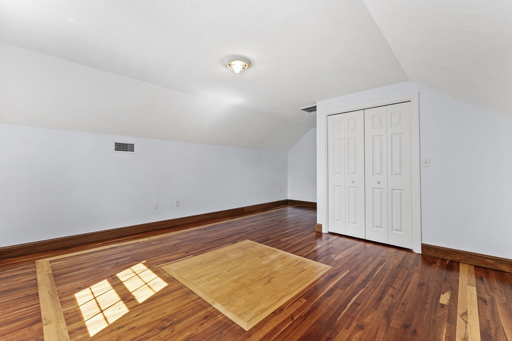 77 Hawthorne Road Waltham, MA 02451 - Photo 21 of 27 a view of a room with wooden floor and white walls
