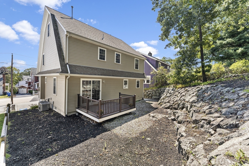 77 Hawthorne Road Waltham, MA 02451 - Photo 23 of 27 a view of a house with a yard