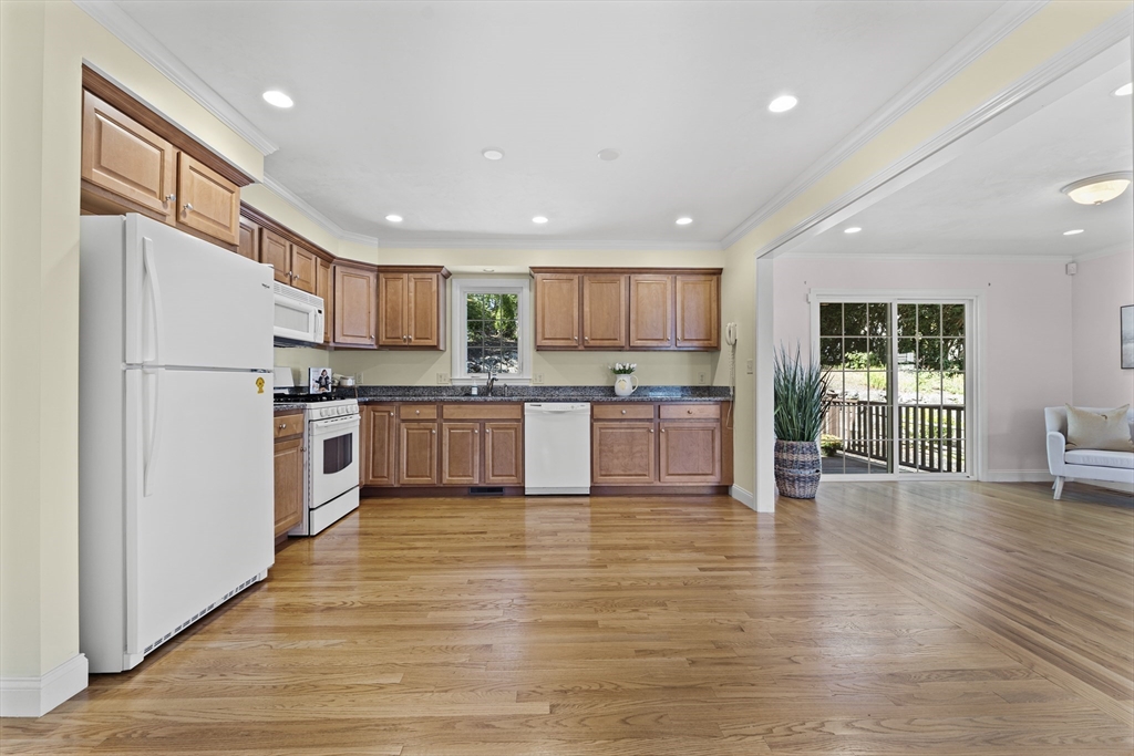 77 Hawthorne Road Waltham, MA 02451 - Photo 9 of 27 a kitchen with wooden floors and white stainless steel appliances