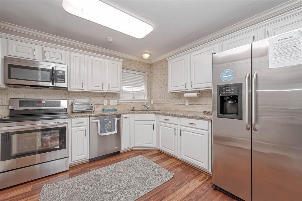 1204 Andrews Street Houston, TX 77019 - Photo 5 of 15 a kitchen with stainless steel appliances granite countertop a refrigerator a stove top oven a sink and dishwasher