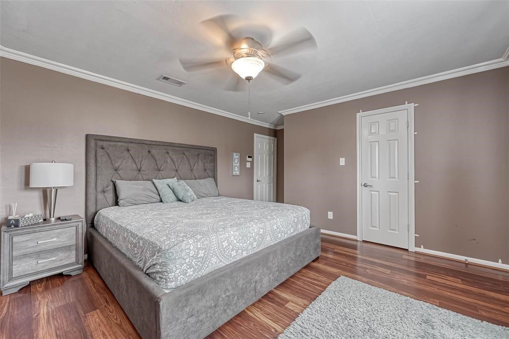 1204 Andrews Street Houston, TX 77019 - Photo 7 of 15 a bedroom with a bed and a chandelier