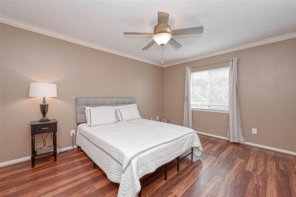 1204 Andrews Street Houston, TX 77019 - Photo 9 of 15 a bedroom with a bed and a chandelier