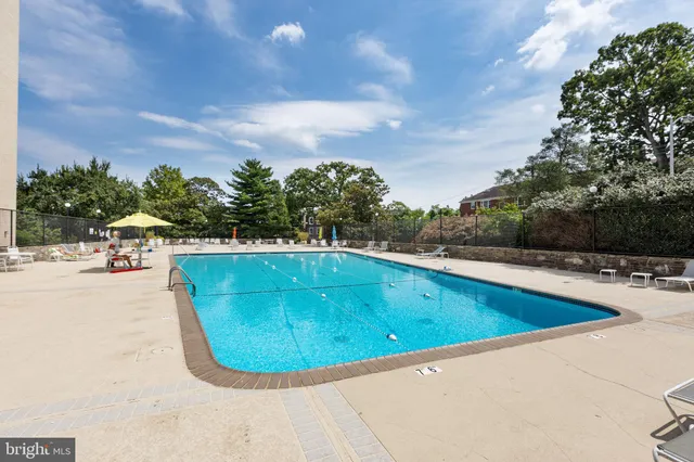 a view of a swimming pool with a lounge chair