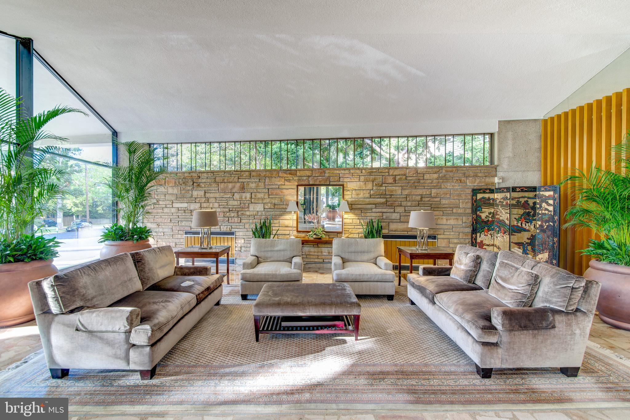 1200 North Nash Street, Unit 1155 Arlington, VA 22209 - Photo 5 of 23 a living room with furniture and a large window