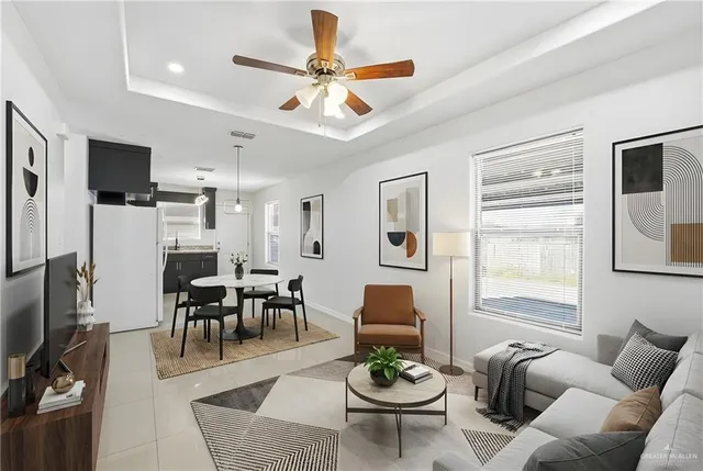 a living room with furniture kitchen view and a window