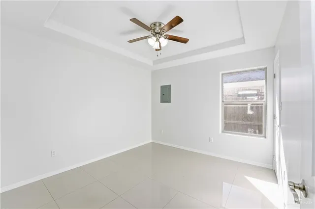 an empty room with a window and a ceiling fan
