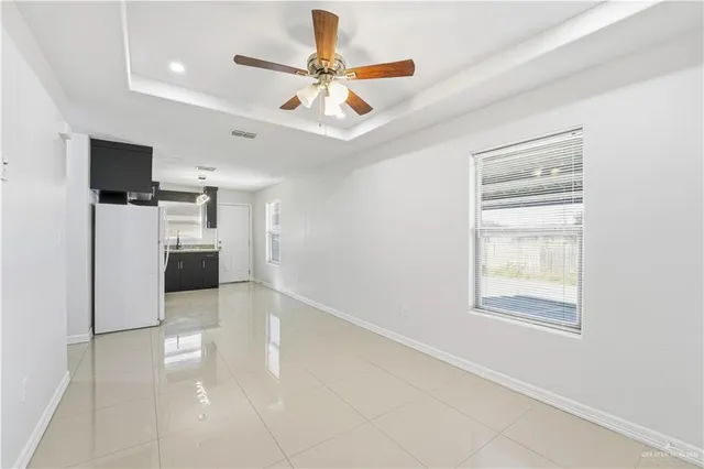 a view of a kitchen with a sink and a refrigerator