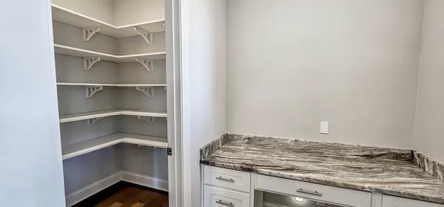 a view of a storage and utility room with closet