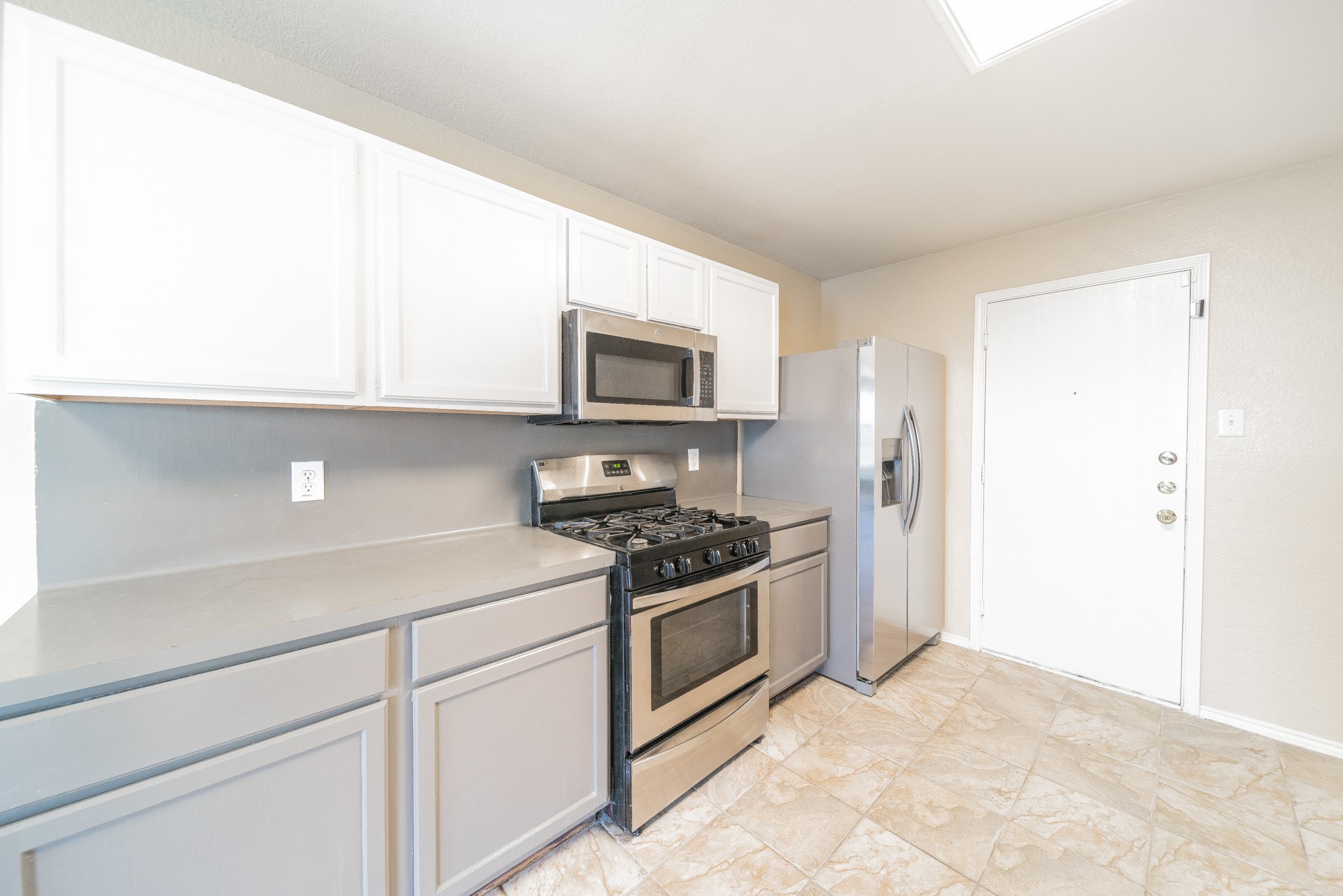 22802 Sherioaks Lane Spring, TX 77389 - Photo 6 of 21 a kitchen with stainless steel appliances granite countertop a stove and a microwave