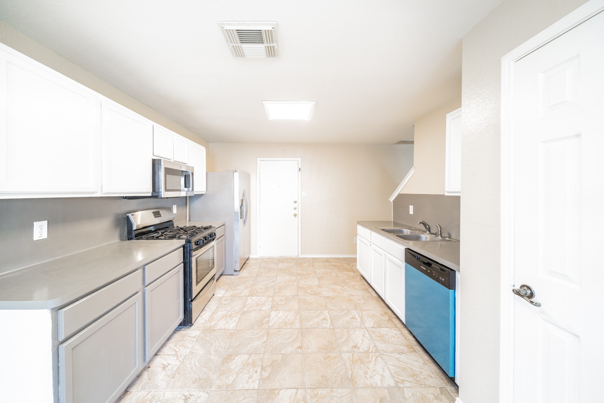 22802 Sherioaks Lane Spring, TX 77389 - Photo 8 of 21 a large kitchen with granite countertop a stove top oven a sink a counter space and cabinets