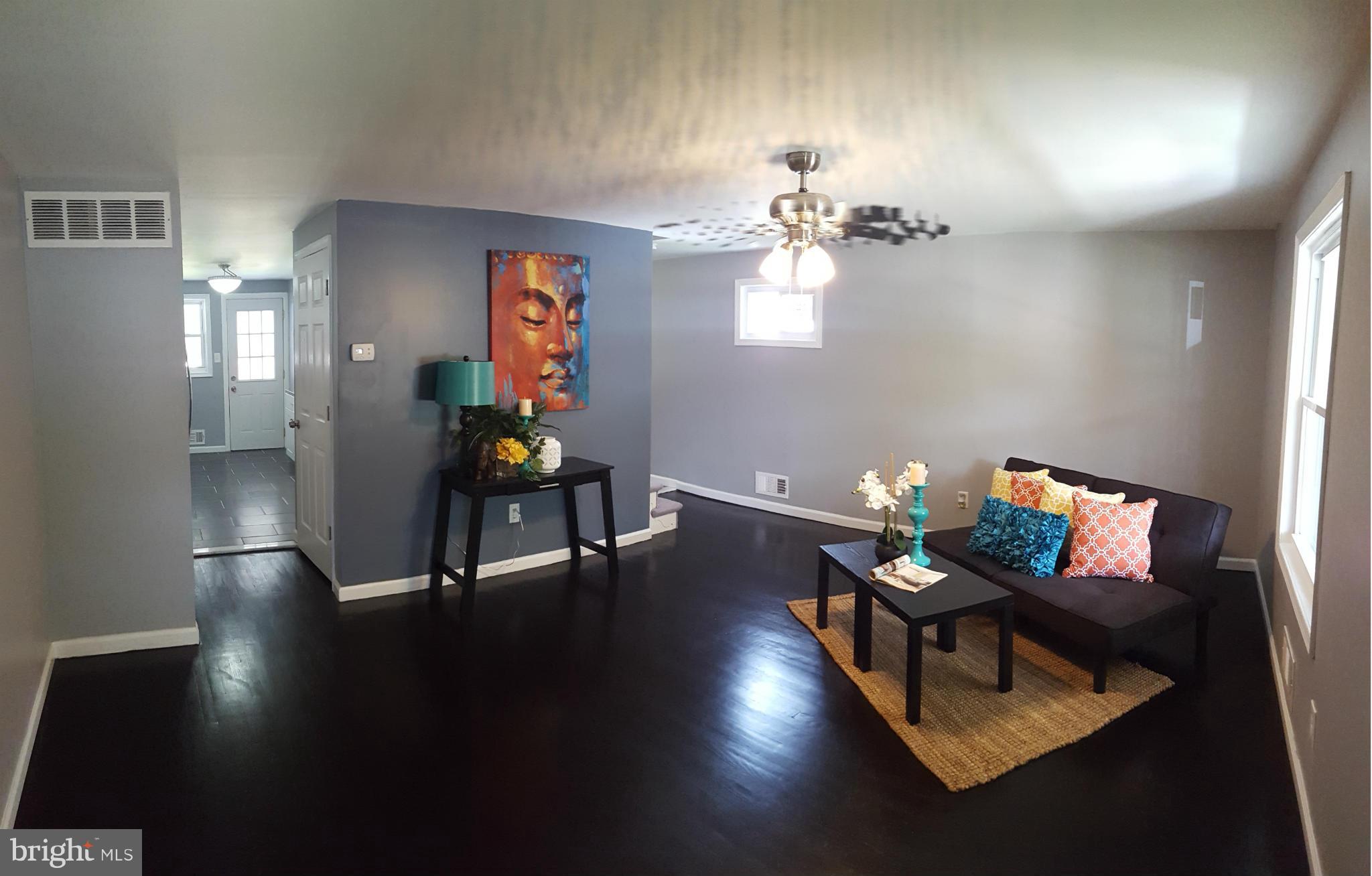 1034 Middleborough Road Baltimore, MD 21221 - Photo 2 of 29 a living room with furniture and wooden floor