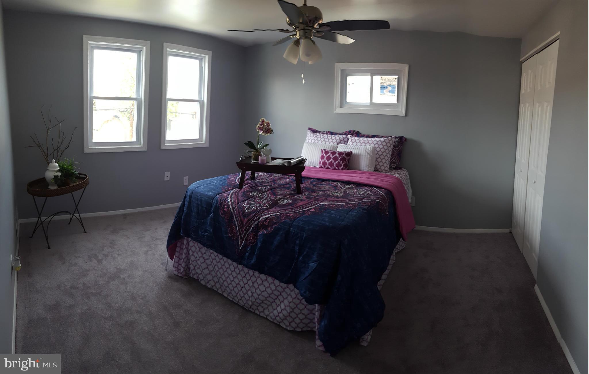 1034 Middleborough Road Baltimore, MD 21221 - Photo 12 of 29 a bed sitting in a bedroom next to a window