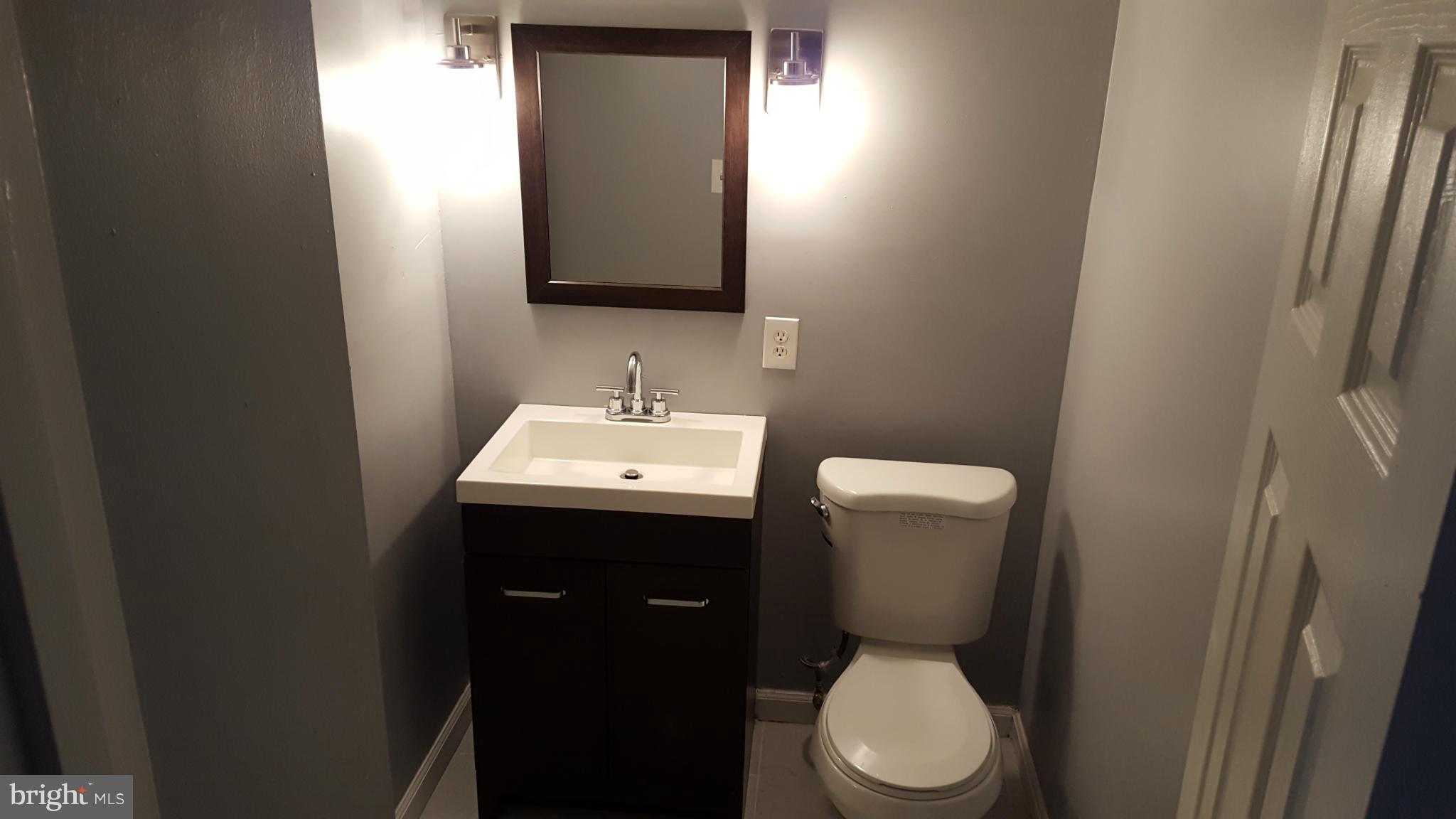 1034 Middleborough Road Baltimore, MD 21221 - Photo 27 of 29 a bathroom with a toilet sink and mirror